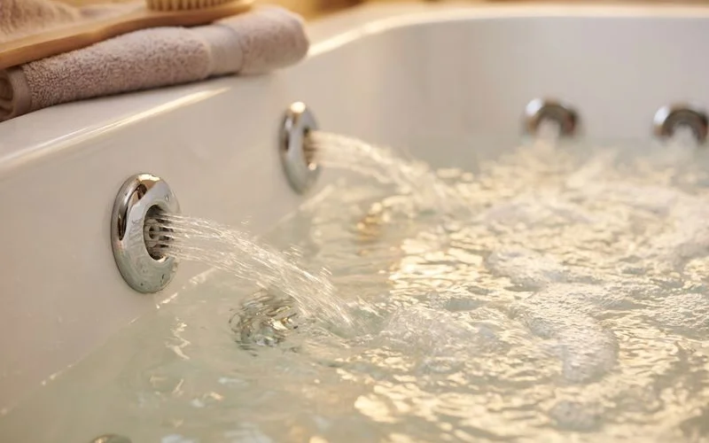 Close-up of hydrotherapy jets in walk-in tub showing water pressure points and targeted massage zones